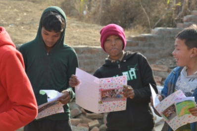 a delighted Nepali young person with his MGIS personal letter