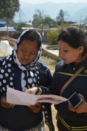 Nimala KC (from UEMS) reads the letter with a youth volunteer from Jhanuwarashi